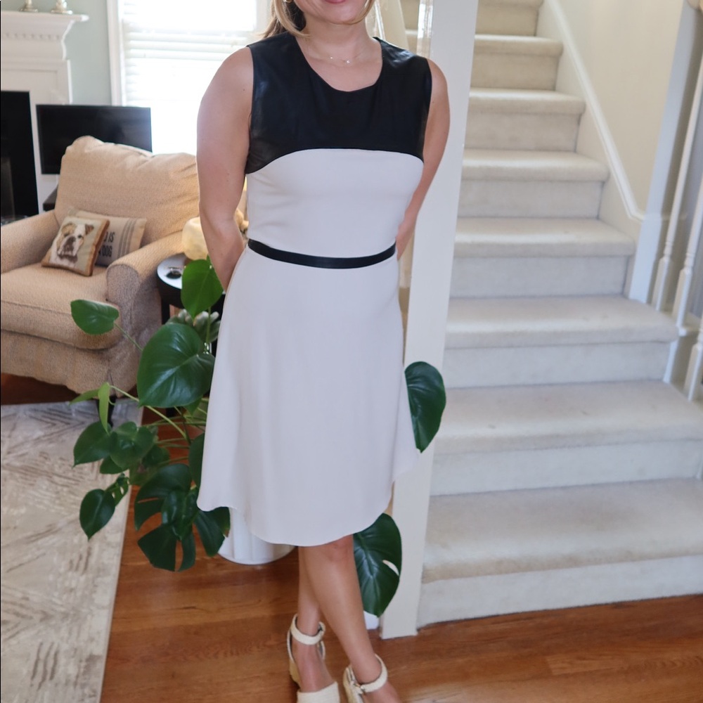 Lightweight cream dress with black faux leather accents.